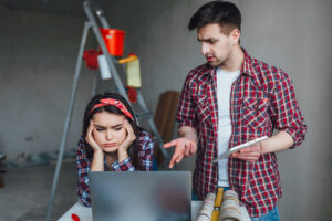 Young woman and man with arguing during renovation in apartment.